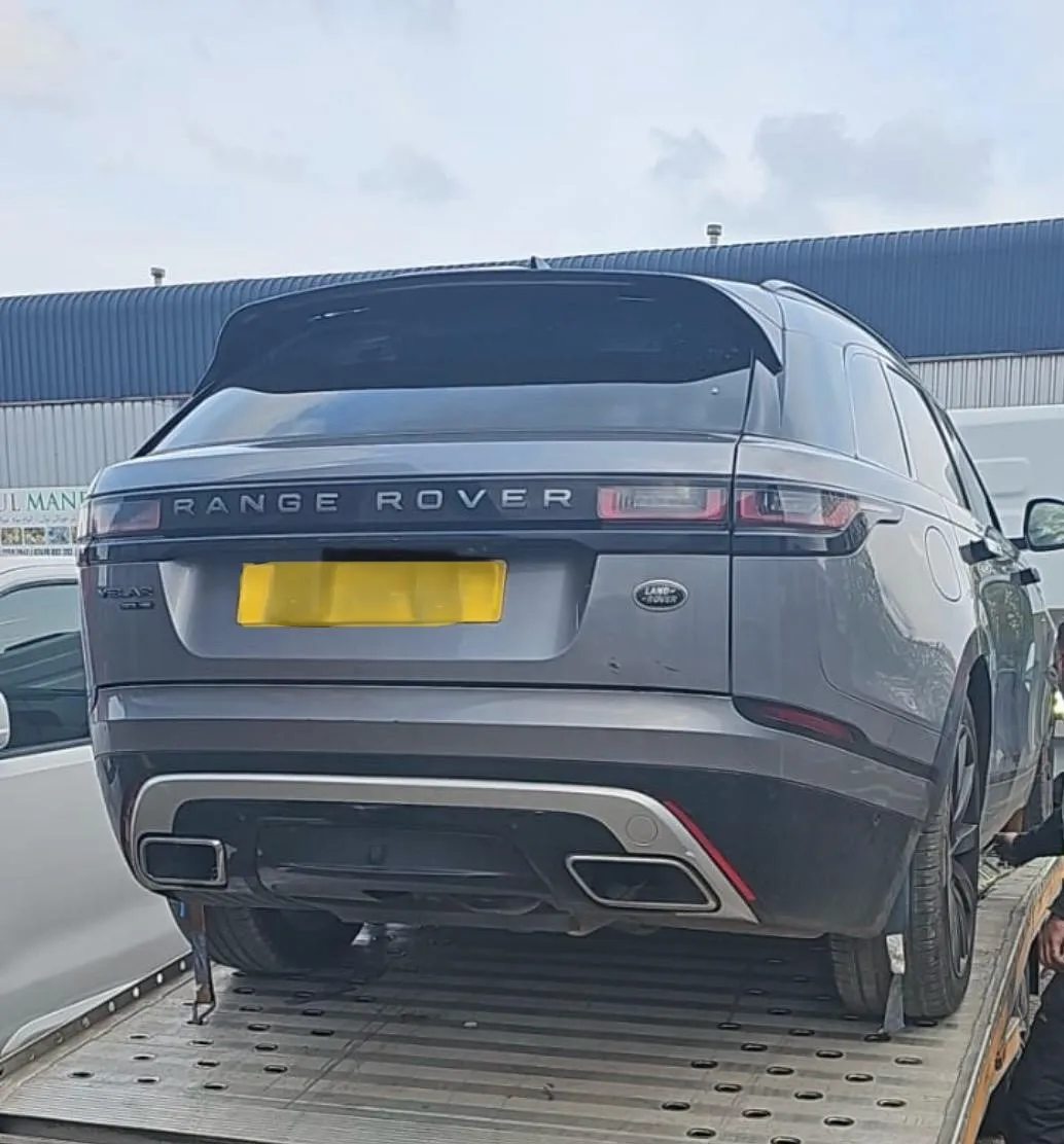 Silver Range Rover Velar on flatbed transporter being collected for engine service – JLR Engine Specialists offers nationwide fitting with 12-month unlimited mileage warranty