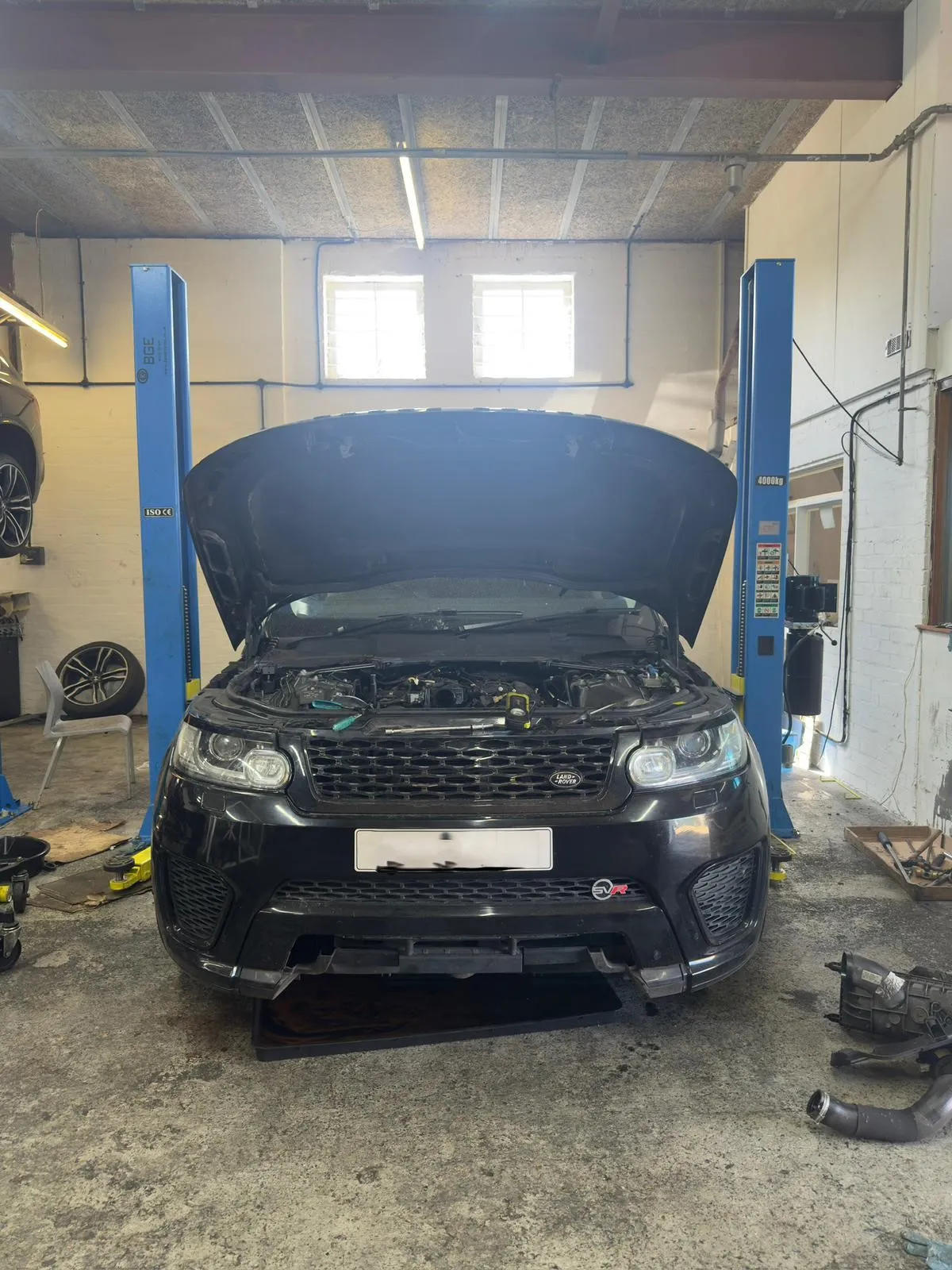 Black Range Rover Sport SVR with engine bay open for service at JLR Engine Specialists – IMI-certified technicians servicing high-performance Land Rover models